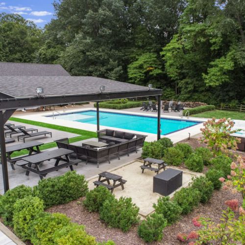 Backyard Oasis with Main House Heated Pool (open May 1-October 31), Hot Tubs (open all year long!), Pergola Lounge Area, Poolside Fire Pit & Sandbox for the Kiddos!