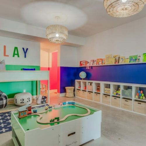 The playroom of your kiddos dreams - stocked with legos, a Melissa & Doug train set, tons of toys and books. It's sure to keep the little ones entertained for hours!